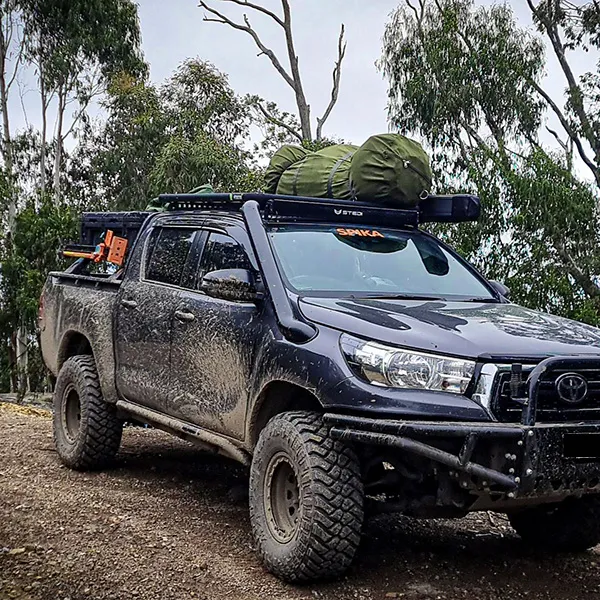 Toyota Hilux carrying camping equipment with a Wedgetail Adventure roof rack